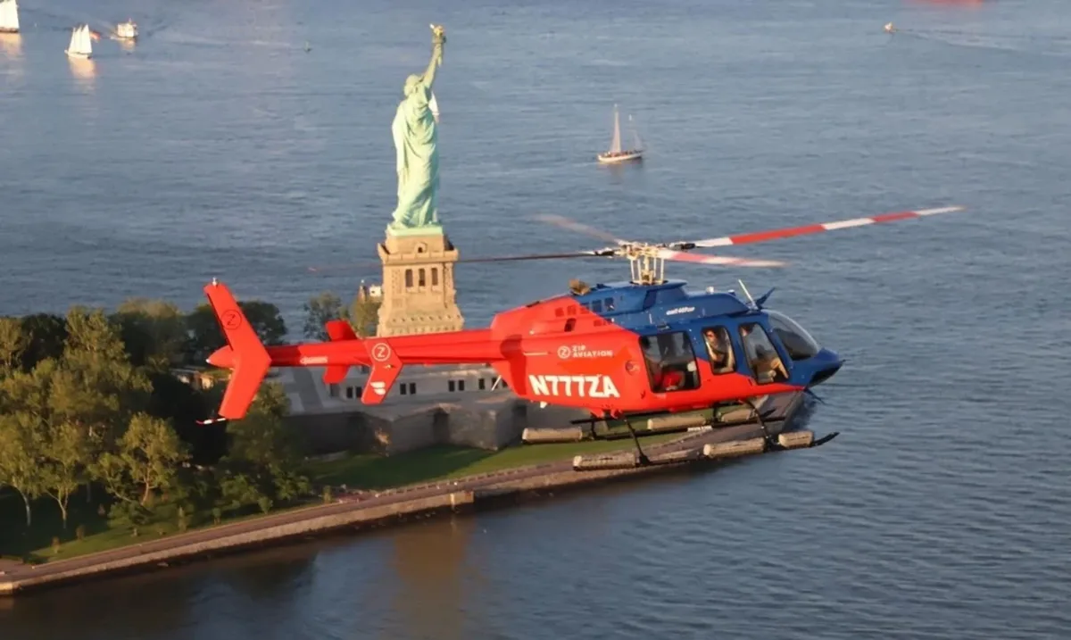 Helicopter flying beside the Statue of Liberty