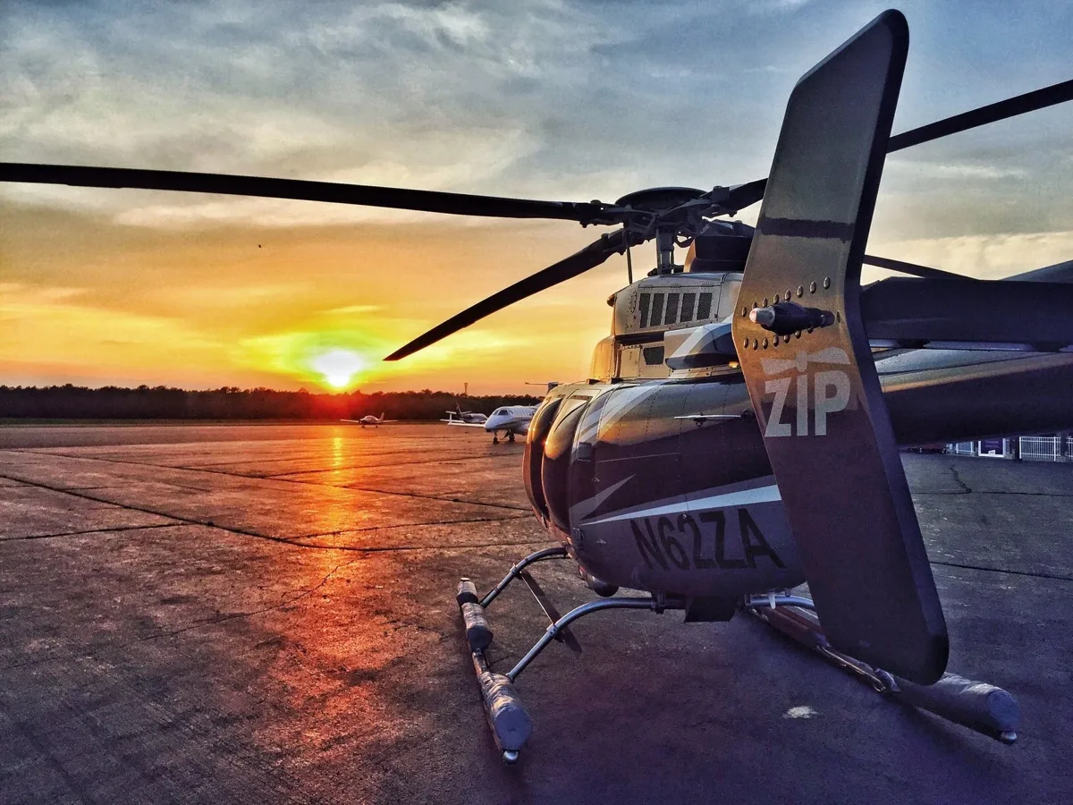 Helicopter on an airfield at sunset